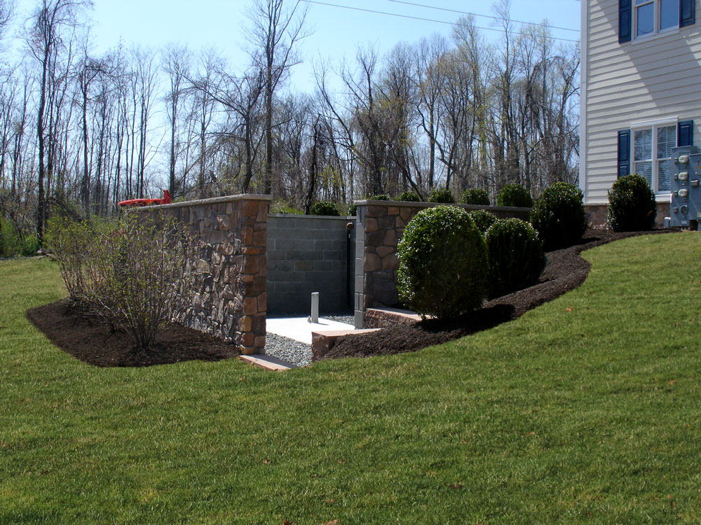 Stone wall and landscape to obscure septic and electric