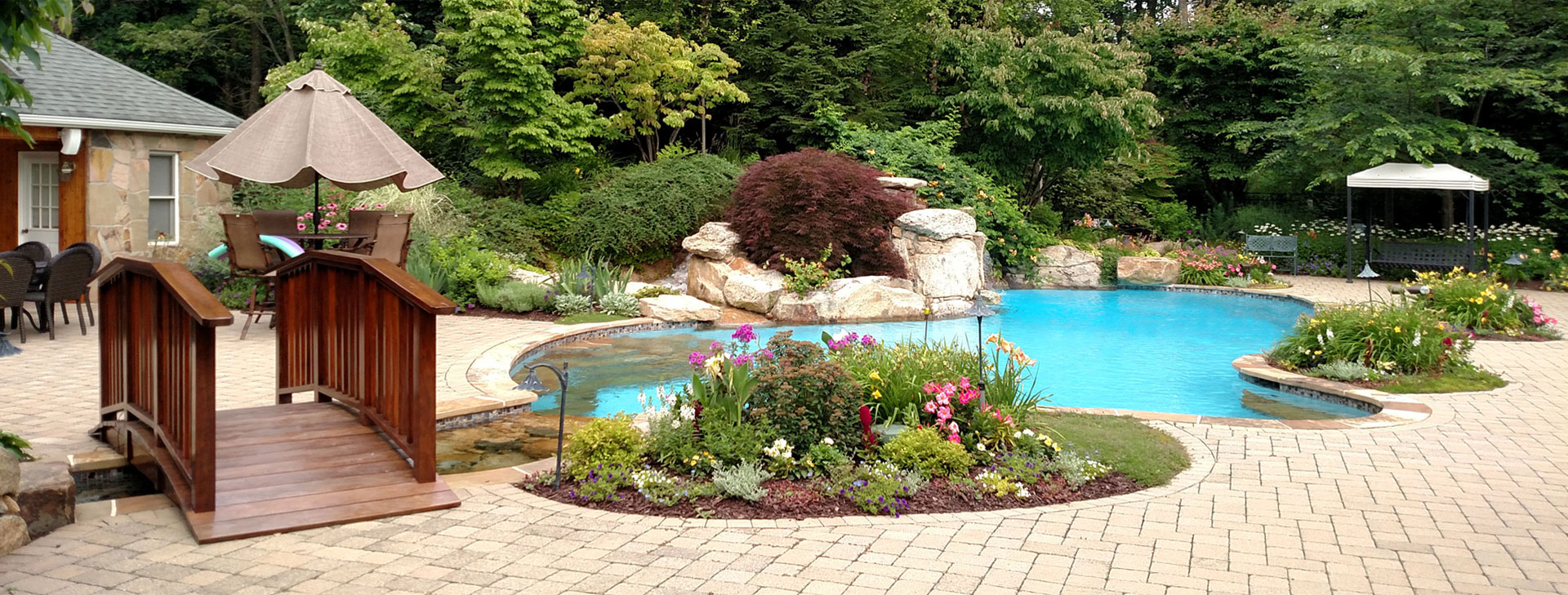 Hardscape with water feature, bridge and pool
